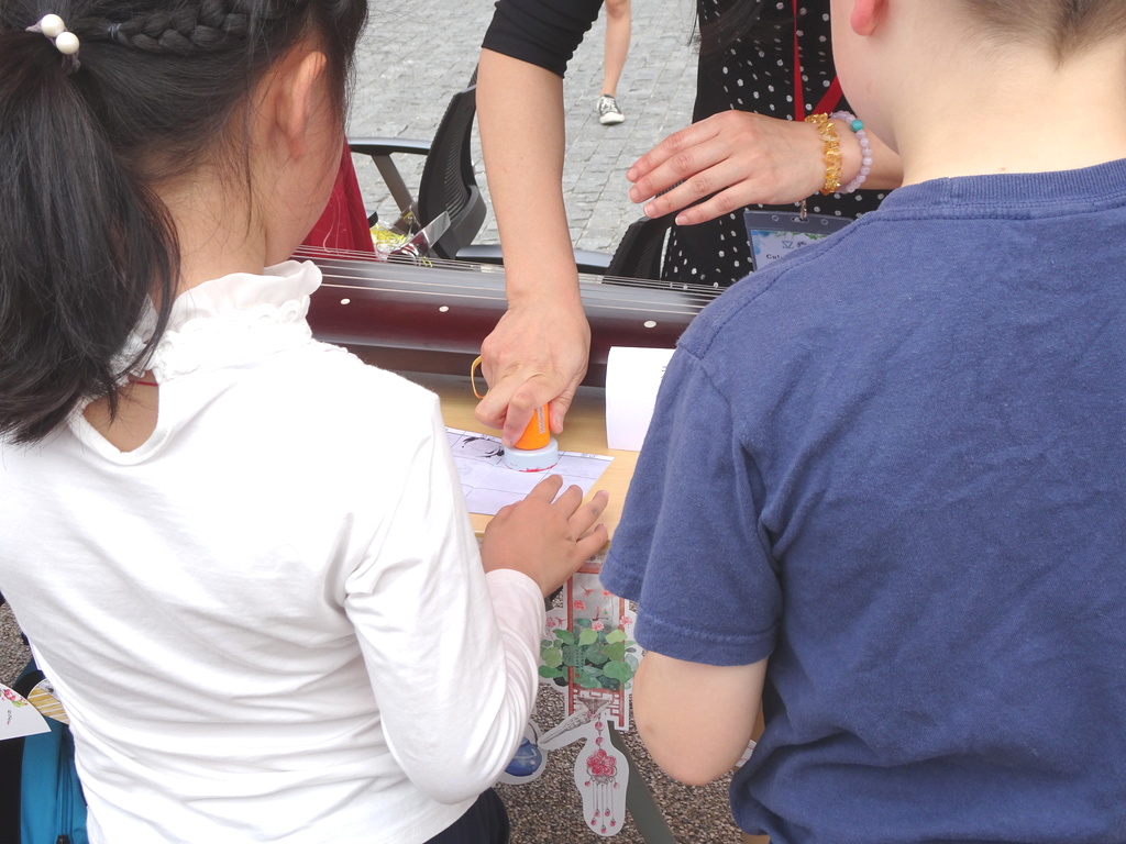 Two children getting their passports stamped