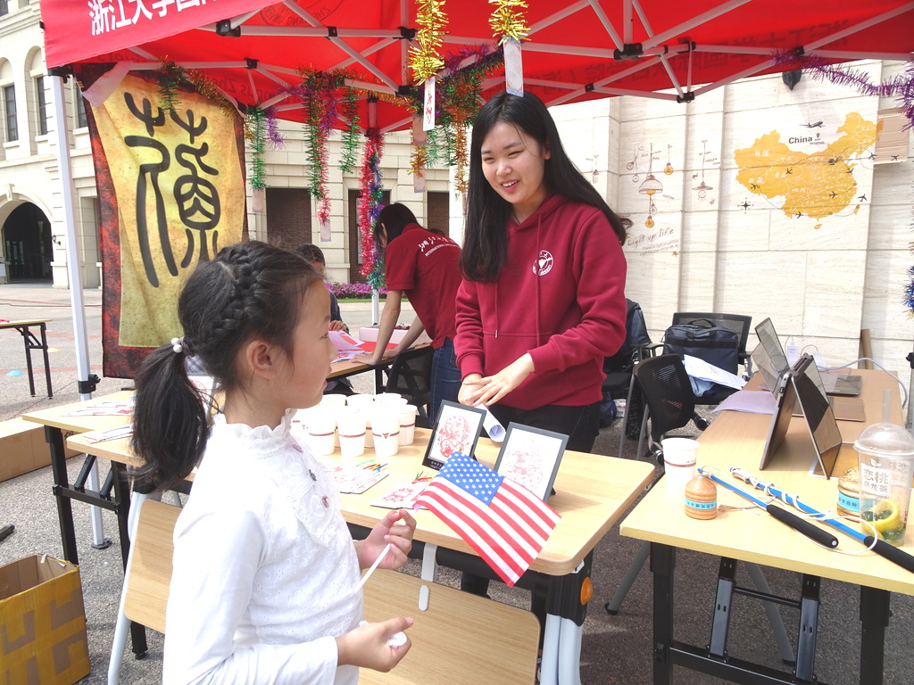 Student helping a child at a stall