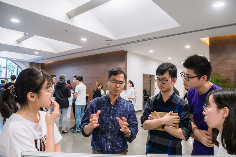 students discussing their poster design